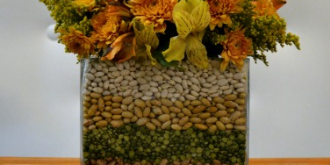Make a simple fall flower arrangement by layering beans, lentils, peas and corn between two glass vases