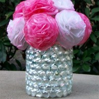 Flower vase made from a mayonaise jar covered in clear marbles