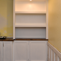 DIY built-in bookcase wall - one side painted with lighting installed