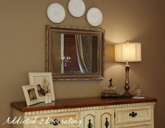 Master bedroom makeover--painted dresser, dresser makeover, plates hung on wall, flea market frame, old decorative books.
