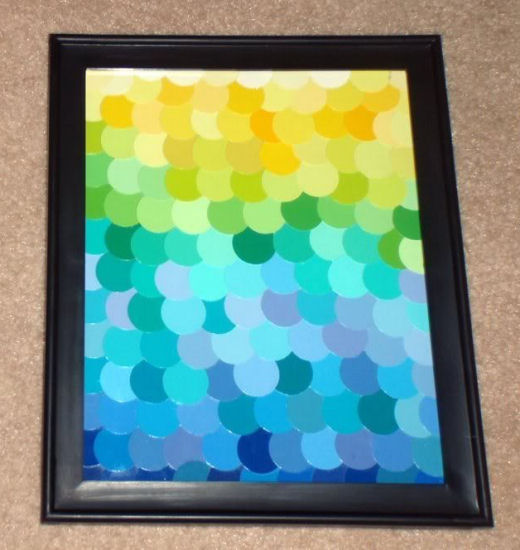 Decoupaged multi-colored circles cut from paint chips and framed to create inexpensive art