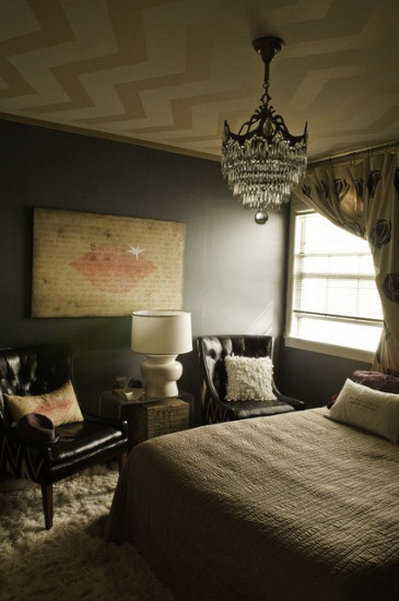 Bedroom with dark dramatic walls and a chevron pattern painted on the ceiling