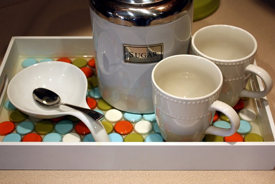 Serving tray tiled with bottle caps set in epoxy