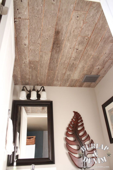 bathroom ceiling clad with reclaimed weathered wood planks