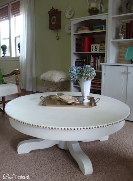 Coffee table makeover from Pink Postcard - after - painted white round coffee table with nail head trim accent