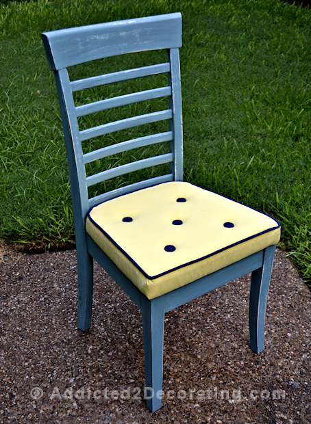 Reupholstered dining chair with welt cord and buttons