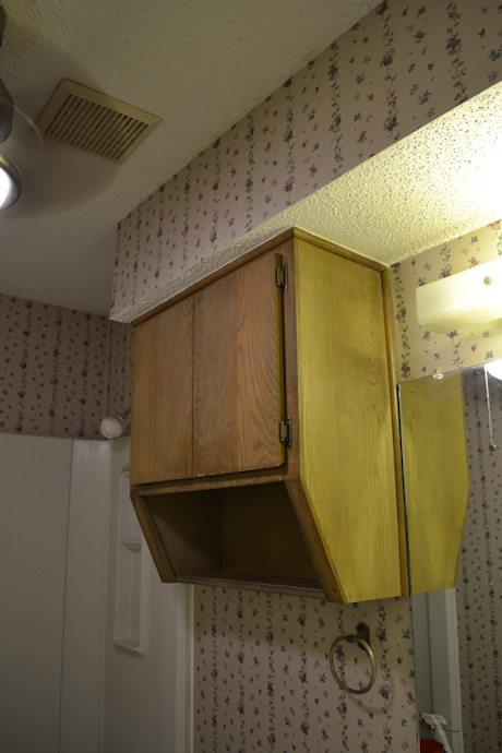 Bathroom makeover - cabinet above the toilet makes the room look smaller