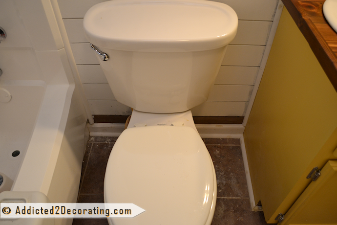 Bathroom makeover day 15 - trim behind toilet and around the tub