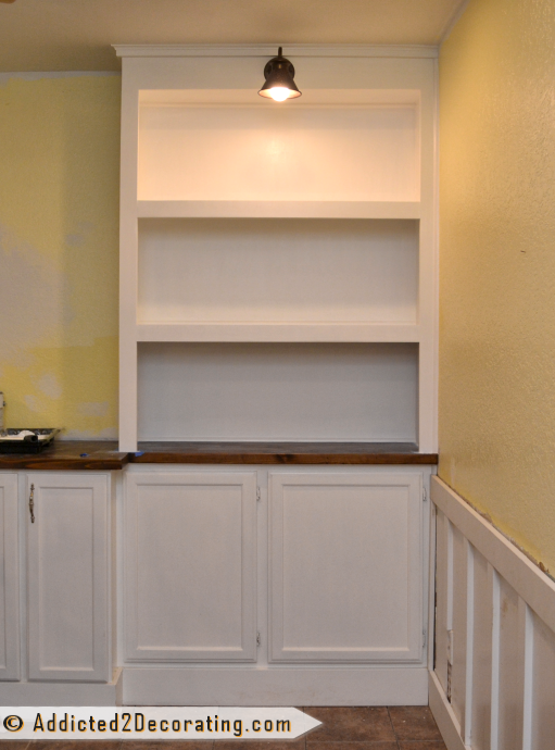 DIY built-in bookcase wall - one side painted with lighting installed