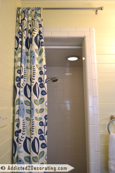Decorative shower curtain in a tiny condo bathroom - after makeover
