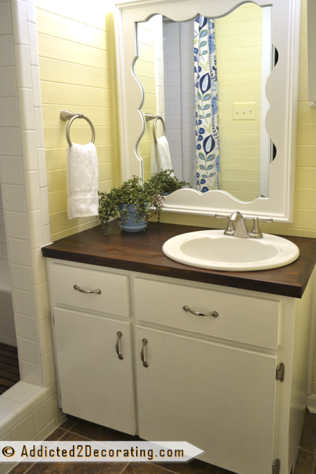 Painted vanity with new wood countertop in condo bathroom makeover