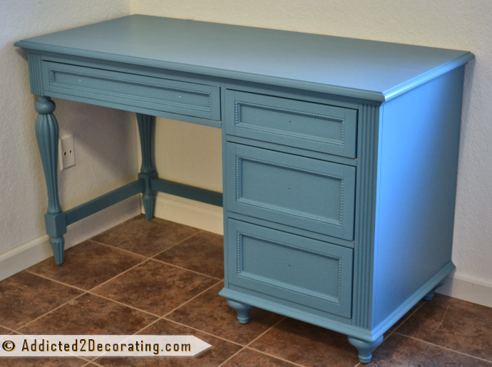 White room, turquoise desk