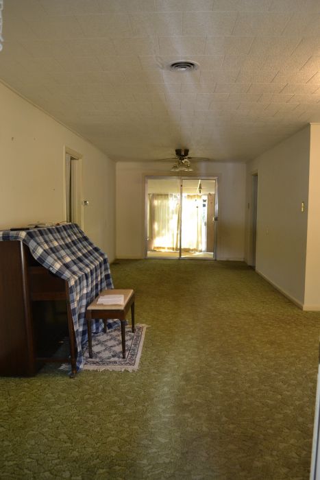 Entryway with old green carpet