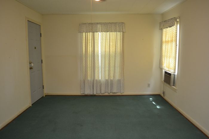 Matt's game room with original hardwood floors hidden under 30-year-old teal carpet