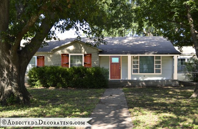 White limestone house, stained shutters, stained front door