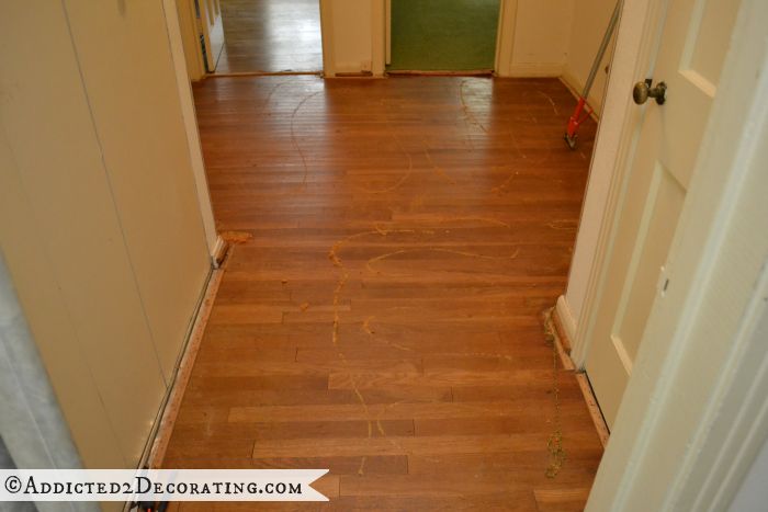 Hallway with green carpet removed from original hardwood floor