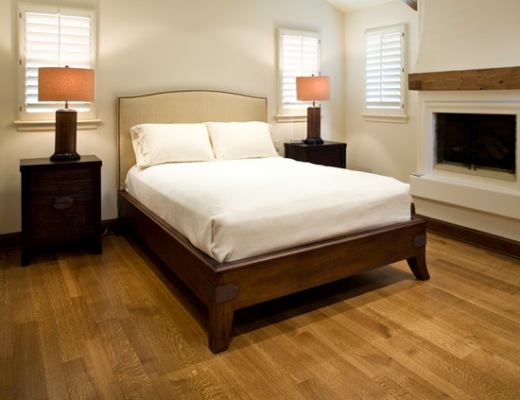 Stained wood bed frame with upholstered headboard, via Houzz