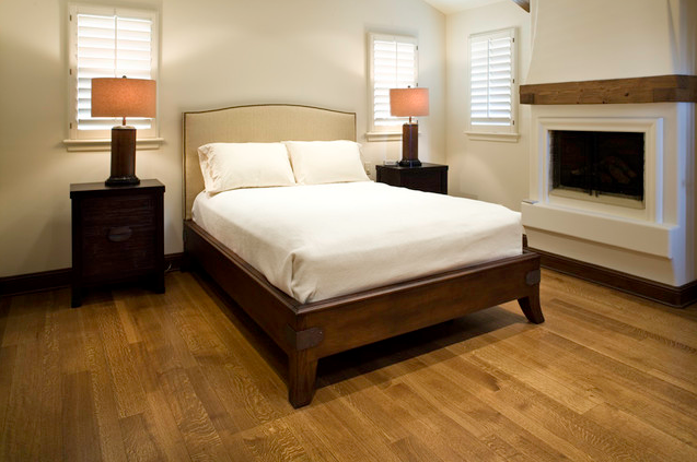 Stained wood bed frame with upholstered headboard, via Houzz