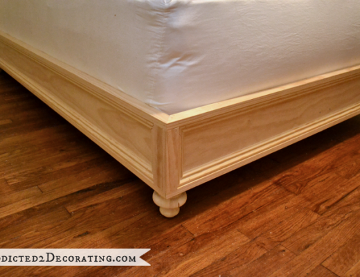 DIY raised platform bed frame with the decorative trim added, from Addicted2Decorating.com