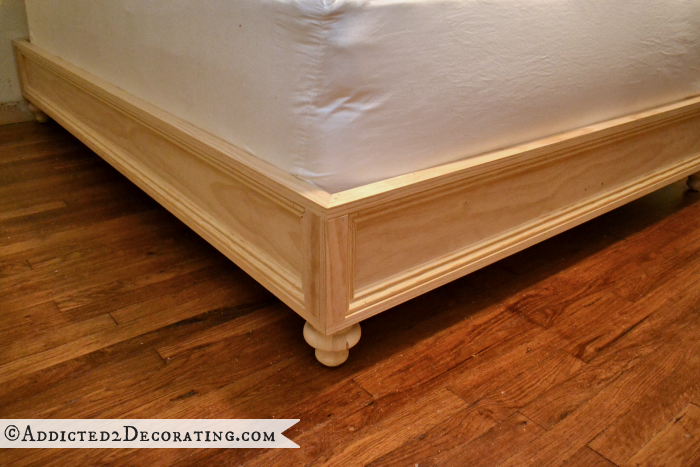 DIY raised platform bed frame with the decorative trim added, from Addicted2Decorating.com
