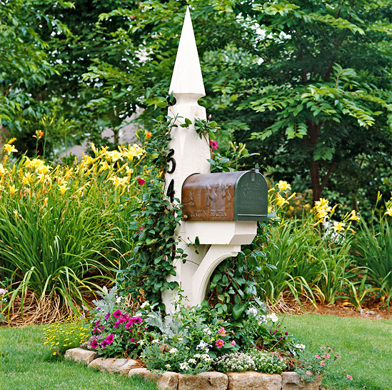 copper mailbox on white mailbox post with beautiful landscaping via BHG