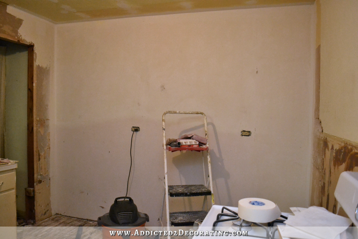 Wall skim coated with drywall mud to hide roughness after removing wallpaper