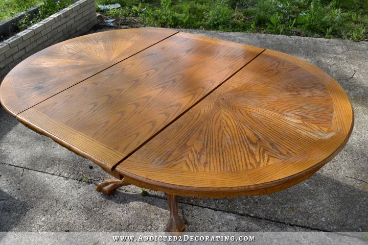 Round oak pedestal base dining table with large leaf to extend the table