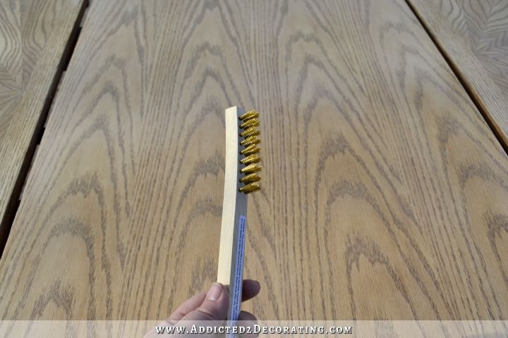 To ceruse an oak table top, use a wire brush to open up the grain of the wood