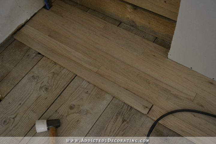 hardwood flooring installation - use pry bar to close gaps on last piece of the row