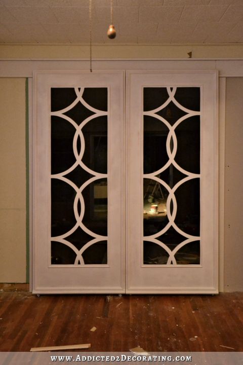 Rolling French doors with circle fretwork inspired by the doors of the Palazzo Hotel in Las Vegas