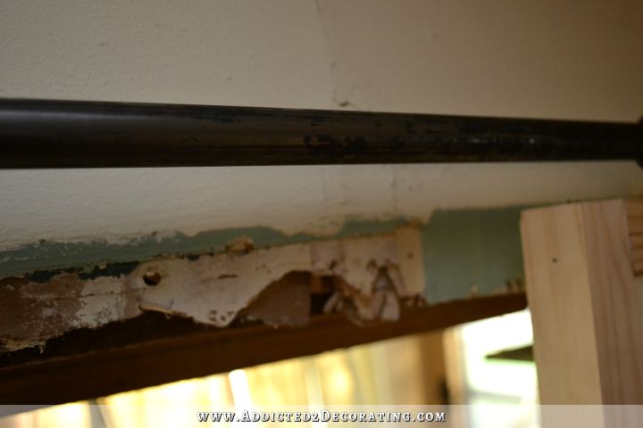 DIY rolling barn door style hardware made from black steel conduit