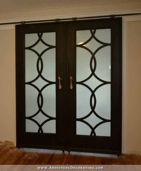 DIY French doors with circle frework panels, installed on DIY barn door hardware