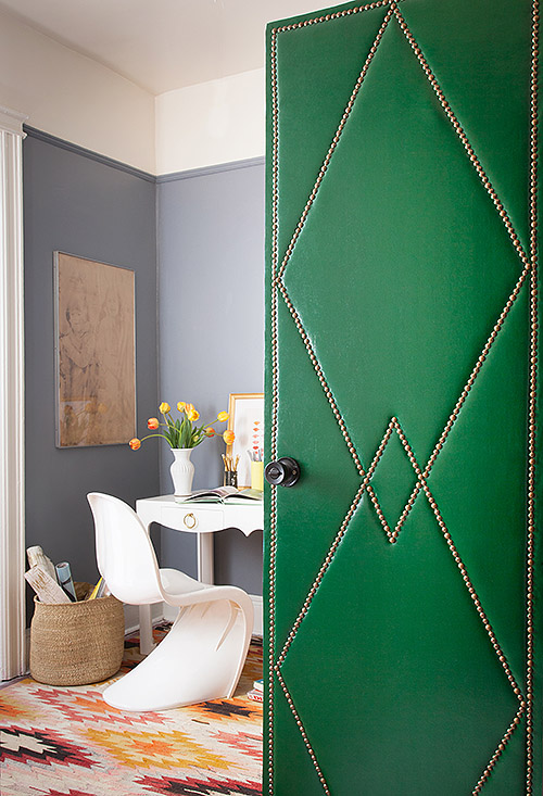 flat panel door ideas - upholstered door with nail head trim in a diamond pattern, via Design Sponge