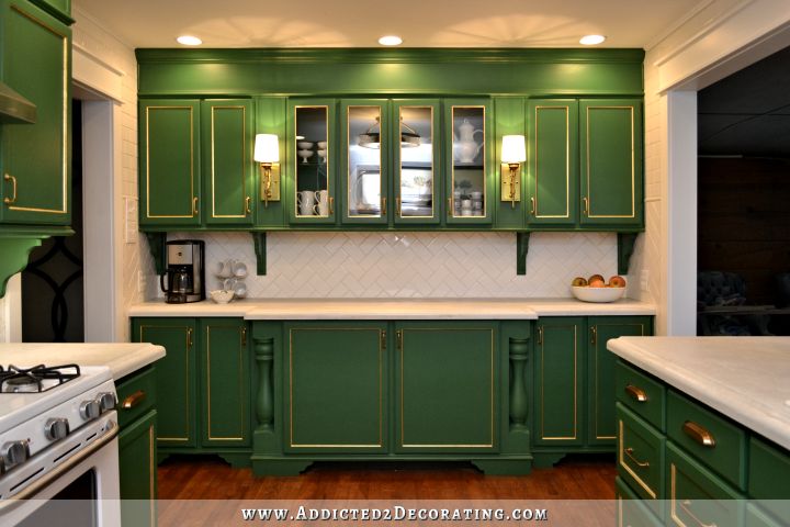 kitchen with green cabinets, white subway tile backsplash, and white concrete countertops