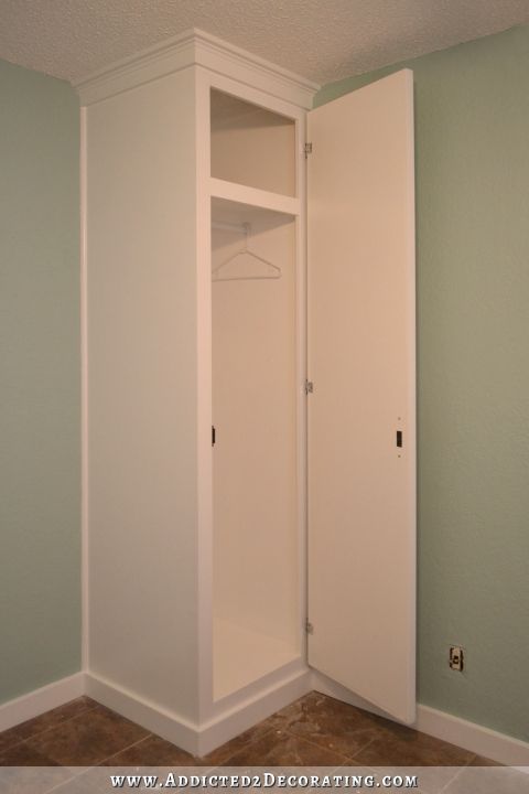 DIY cabinet style built-in closet that provides shelf storage and hanging clothes storage