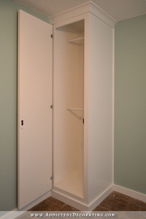 DIY cabinet style built-in bedside closet with two tier hanging storage for clothes