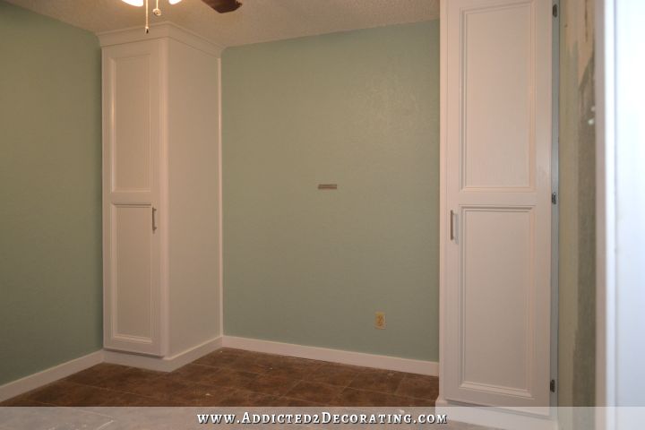 DIY cabinet style built-in closets that flank a bed to add more storage