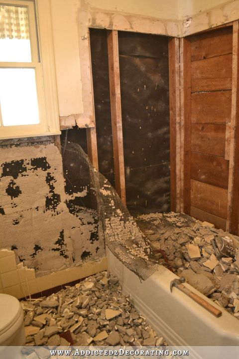 removing tile and thick mortar bed from tub surround and walls in a late 1940s / early 1950s bathroom