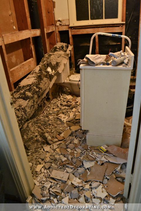 hallway bathroom remodel - original tile floor and subfloor being removed