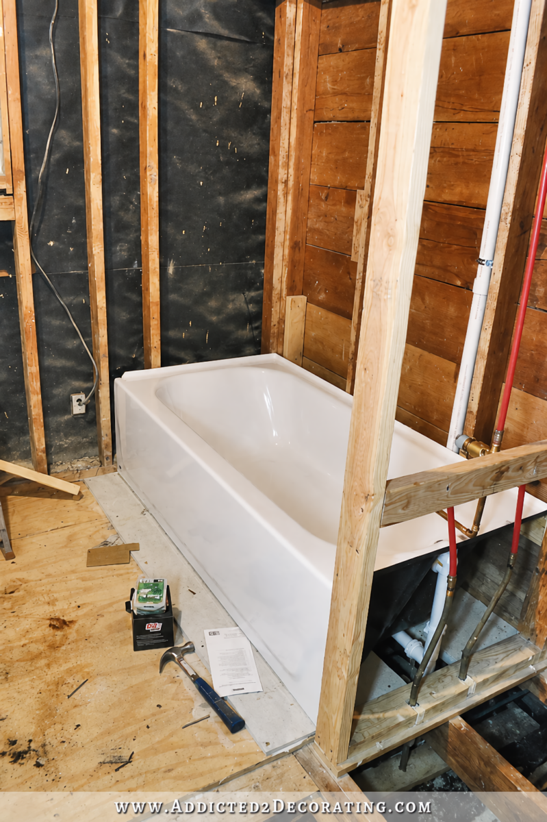 hallway bathroom during initial remodel - installing new bathtub