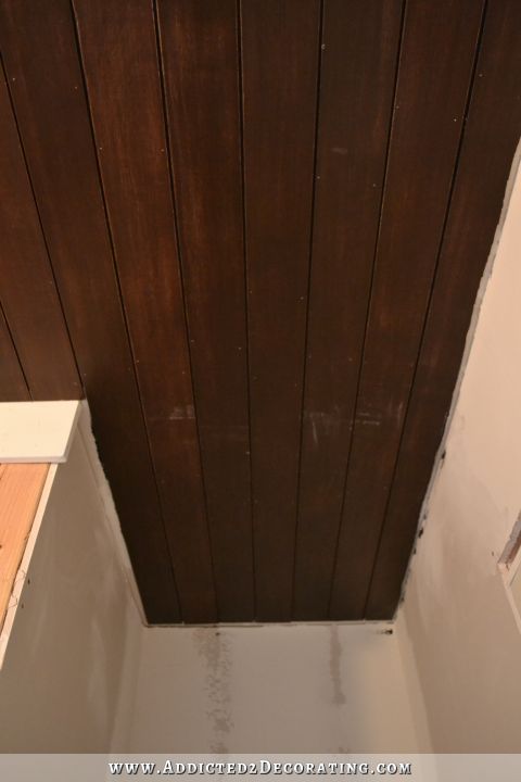 stained wood slat ceiling in hallway bathroom - 2