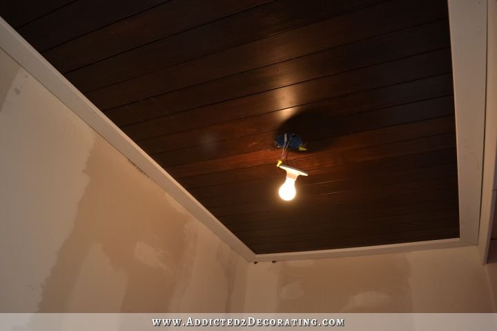 stained wood slat ceiling in hallway bathroom - 3