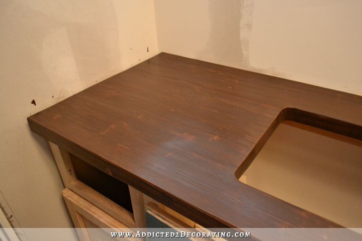 DIY butcherblock style countertop with slight wood grain and knots, and with hole cut for undermount sink