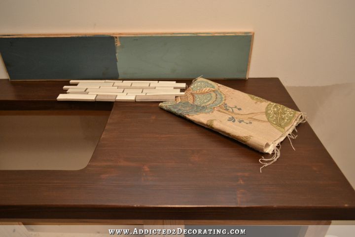 DIY butcherblock style countertop with coordinating paint colors, shower curtain fabric, and mosaic tile for backsplash