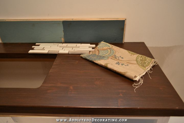 DIY butcherblock style countertop with coordinating paint colors, shower curtain fabric, and mosaic tile for backsplash