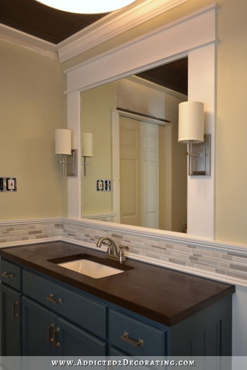 Framed bathroo mirror with integrated sconces