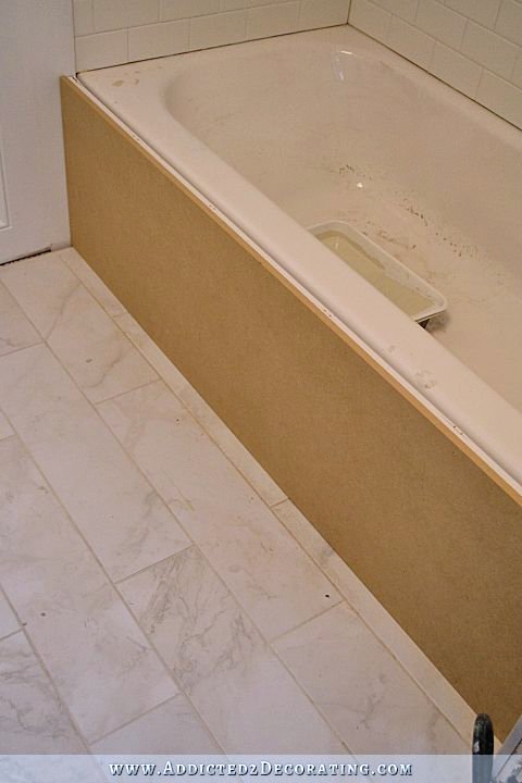 build a DIY tub skirt - step 3 - cover the frame with a solid piece of MDF or plywood