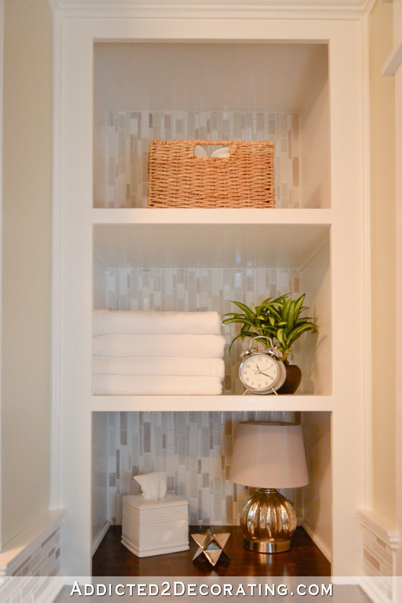 Built-in open shelves to replace linen closet in a bathroom