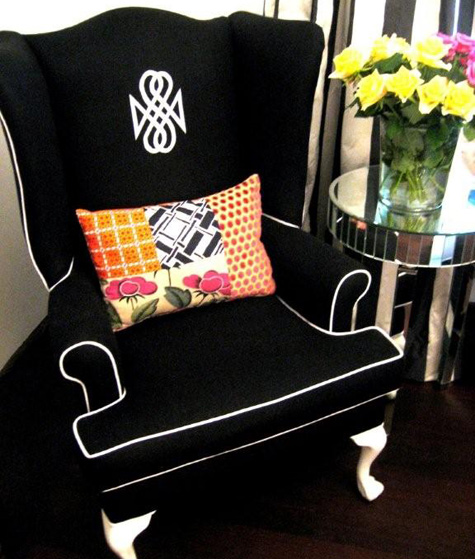 black wingback chair with white piping from Design Sponge