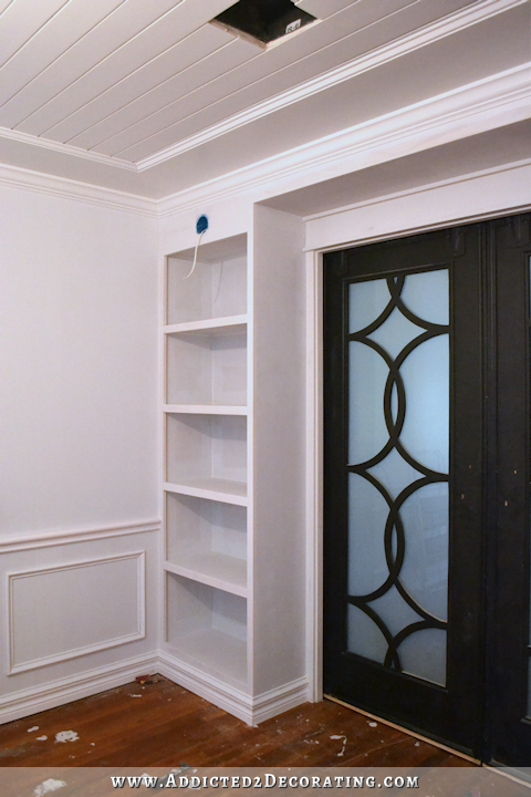 music room built in bookcases after wood filling, sanding, caulking, and priming - 2